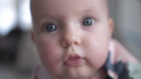 happy infant little boy smiling while looking toward camera, family warmness, pure innocence