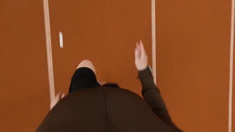 overhead view of a person running on an athletic track