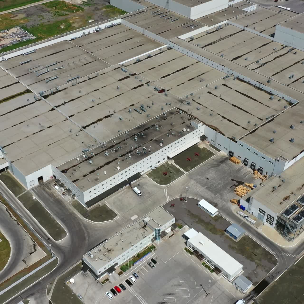 Roofs of industrial buildings. Large manufacture on field. Innovative production plant outside. Industry. Top aerial view.