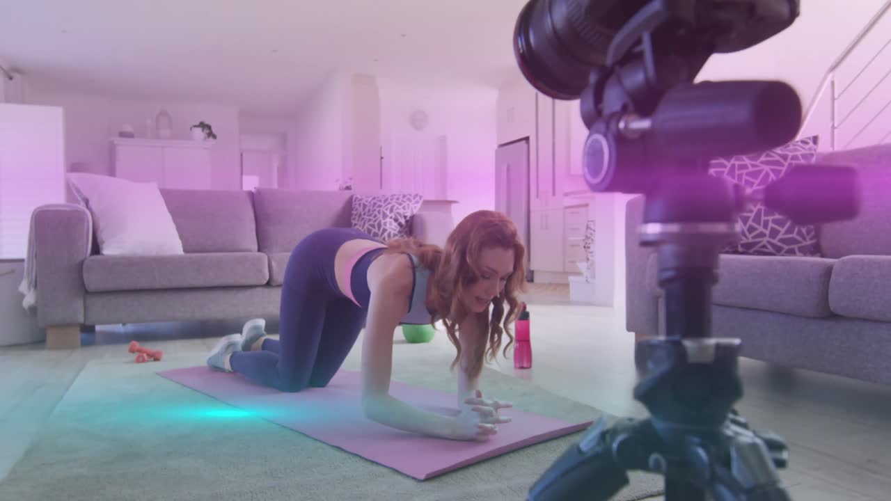 animación de senderos de luz sobre mujer caucásica haciendo ejercicio, haciendo vlog usando cámara