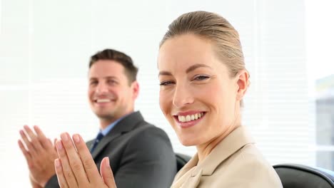 business people clapping at the camera