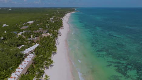 Aerial-Tilt-up-Reveal-of-Iconic-Tulum-Beach-Coastline-on-Sunny-Mexico-Day