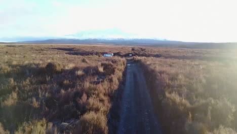 aerial tracking shot of running person tilting up to a snowy mountain