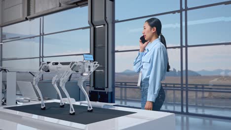 woman interacts with a robotic dog in a modern workplace