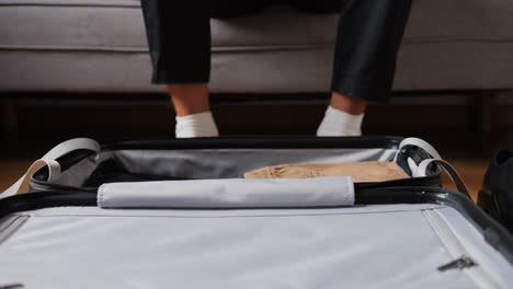 tourism and travelling concept. handsome business man going on holiday, packing his suitcase, checking luggage, sitting on bed and looking at packed things