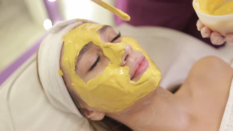 mujer recibiendo un tratamiento de máscara facial