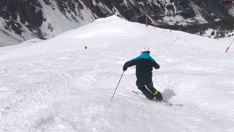 skiing mogules fast and in control on a steep ski slope