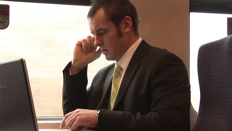 businessman working on a train