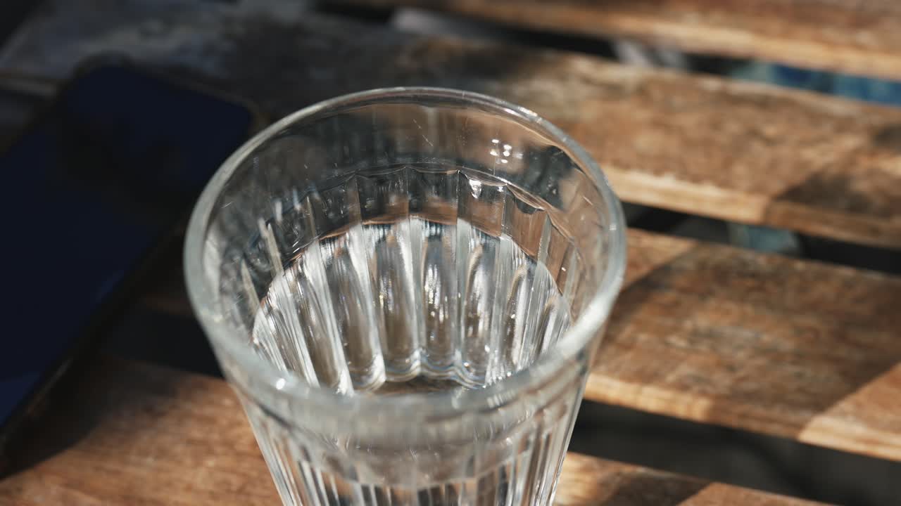 Empty glass of water on a wooden table