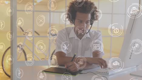 Animation-of-African-American-man-working-with-headphones-over-multiple-white-icons