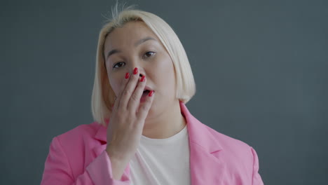 woman in pink blazer with different expressions