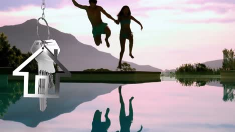 House-keys-and-key-fob-hanging-with-couple-jumping-into-swimming-pool-in-the-background