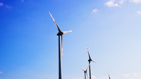 wind turbines producing energy. wind turbines stand tall against a clear blue sky, harnessing wind energy in a sustainable manner during daytime