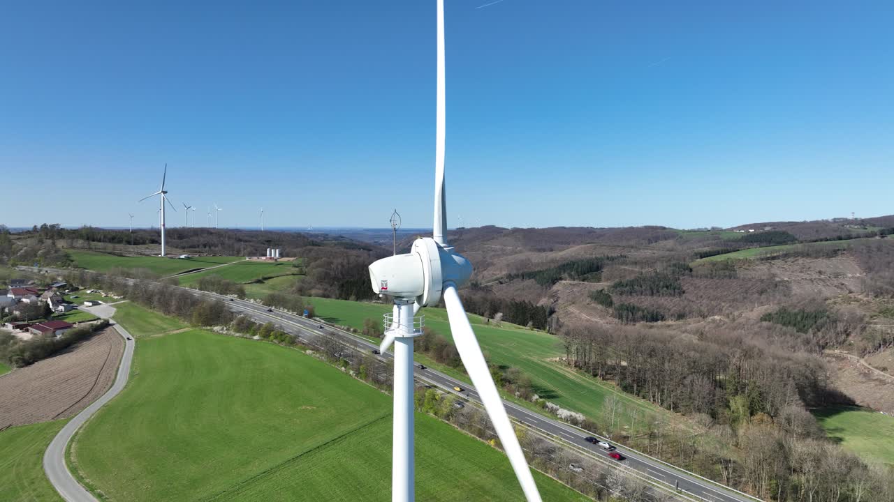 Clean eenrgy production, power from the wind, electricity, renewable energy, wind power, wind turbines in green landscape. Aerial view. close up.