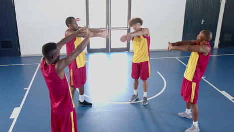 Diverse-basketball-team-practices-in-an-indoor-court