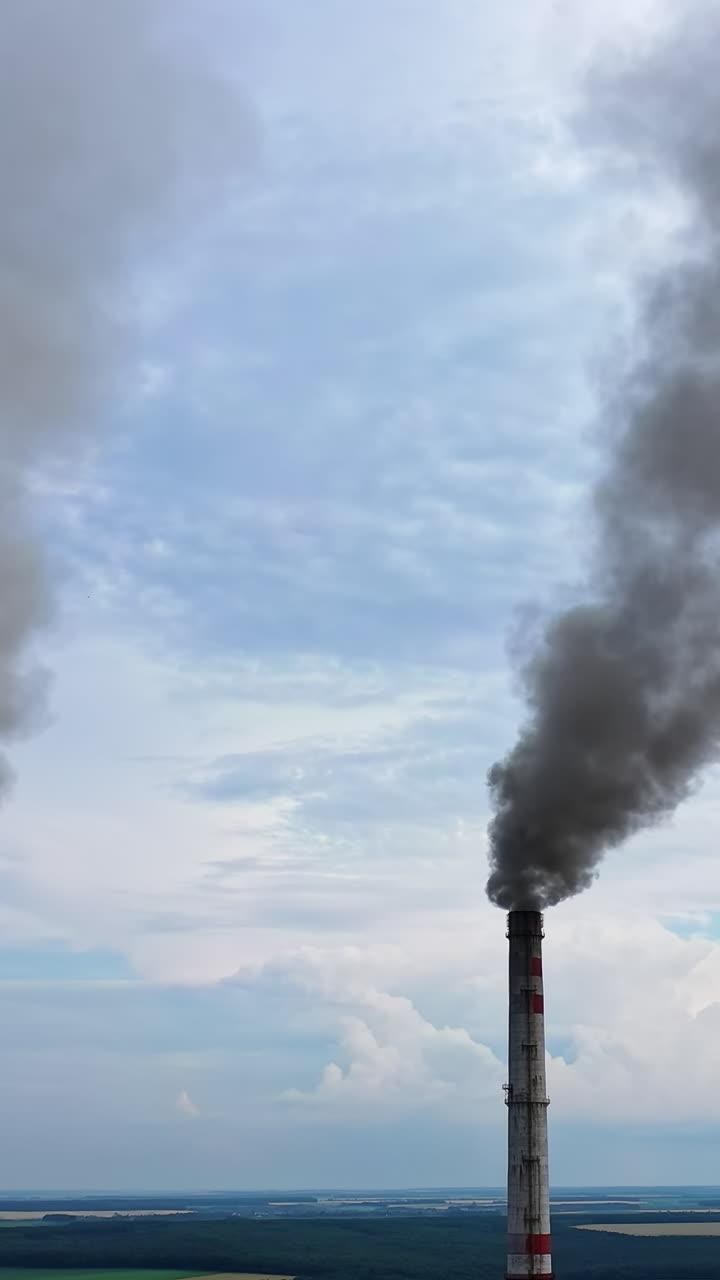 Pipes Throwing Smoke In The Sky. Industrial zone with large smoke from the factory pipes