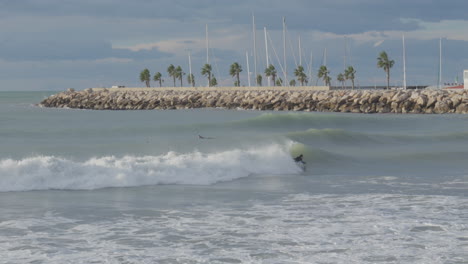 surfer-ride-bodyboard-in-the-pipeline-near-palm-trees