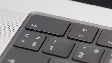 close-up of a laptop keyboard with the esc key highlighted