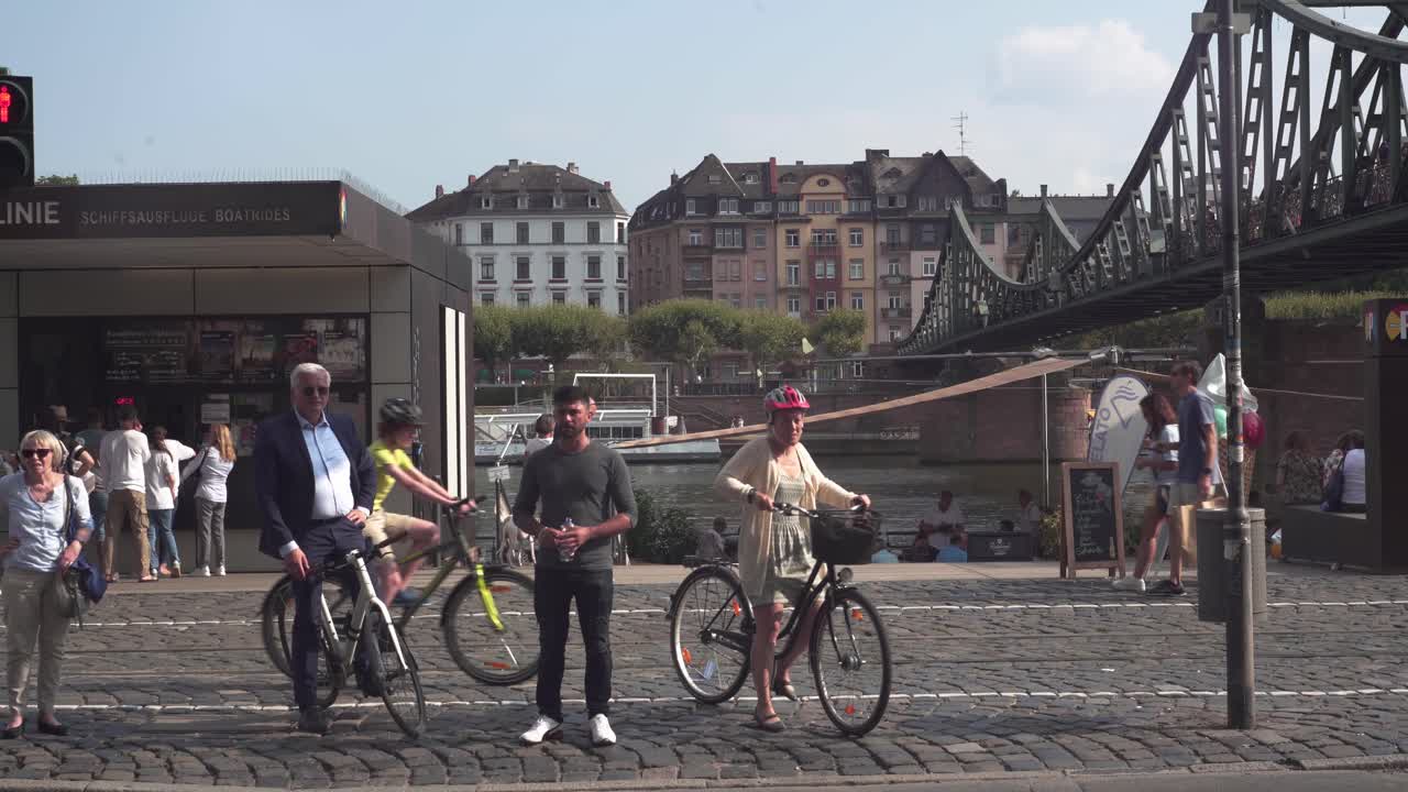 People waiting on a stop light on the streets of Frankfrut in the Summer