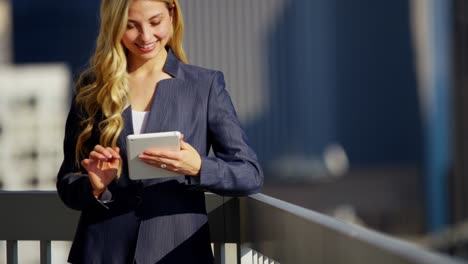 caucasian female business manager using tablet on rooftop