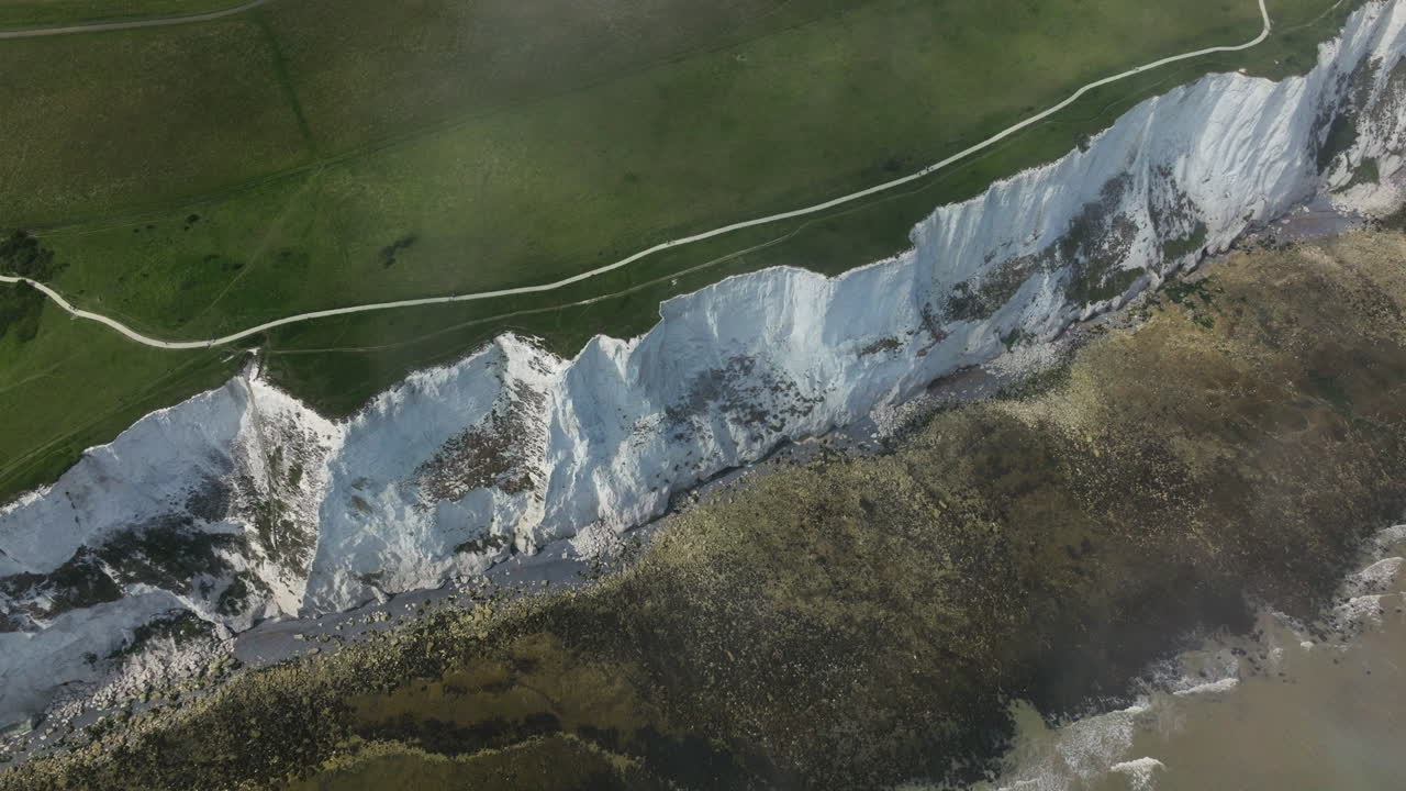 Dover White Cliffs With Streaks Of Black Flint And Rocky Coastline In Kent, England, UK. - aerial shot