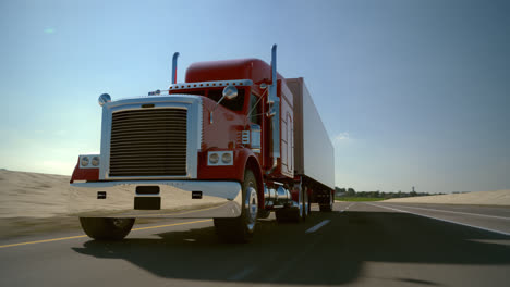 red semi truck driving down a highway