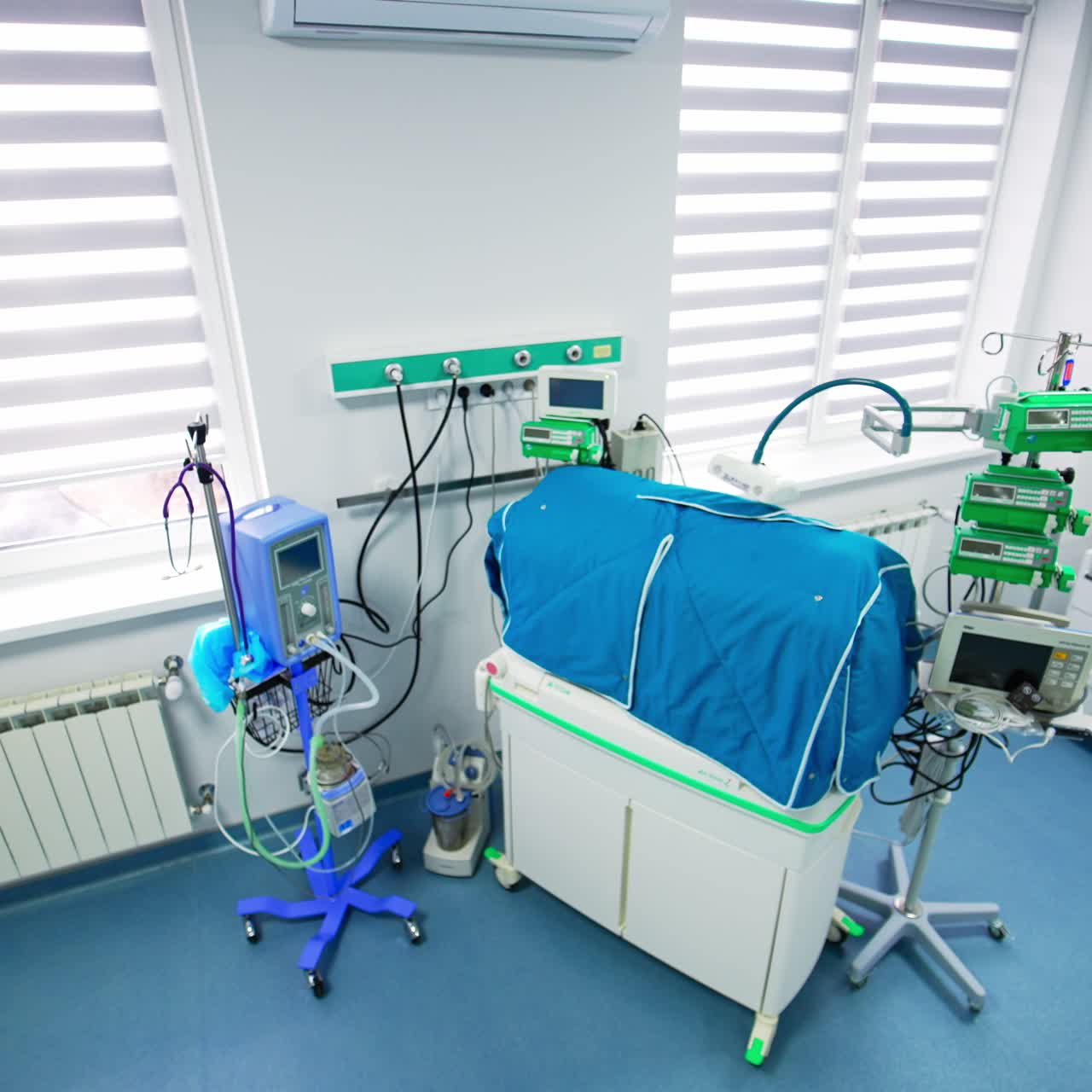 Clean and light ward in modern childbirth hospital with equipment necessary for saving lives of newborn kids. View from above