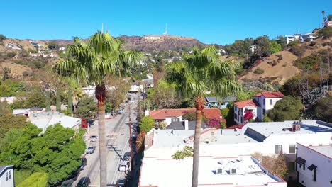 Toma-Aérea-Ascendente-De-Palmeras-Revela-Las-Colinas-De-Hollywood-Y-El-Letrero-De-Hollywood