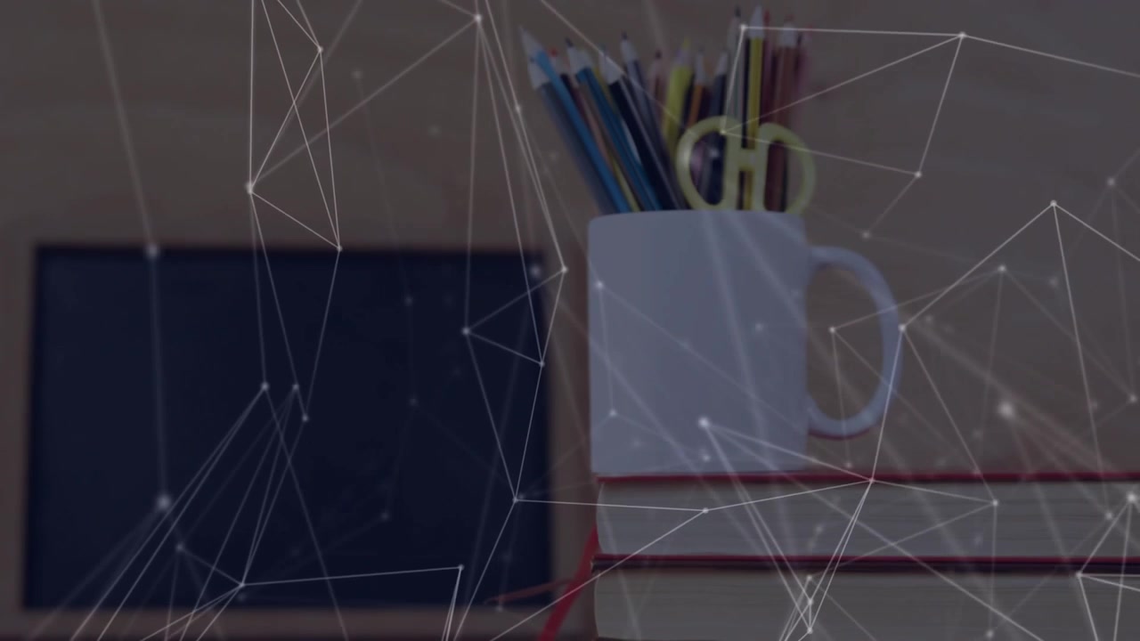 network mesh drifting and weaving around stack with mug of pencils and scissors before chalkboard