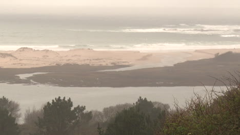 Coastal Landscape with Dunes and Estuary on a Cloudy Day