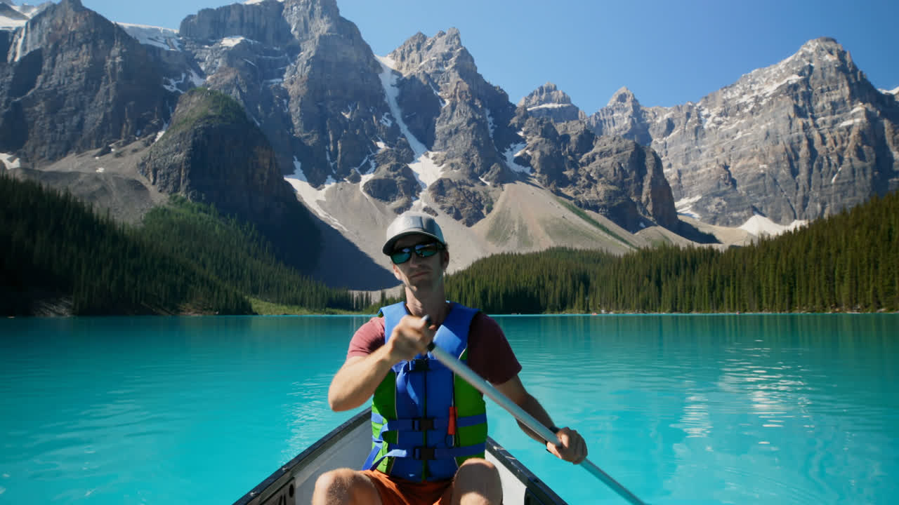 Man rowing a boat in river at countryside 4k