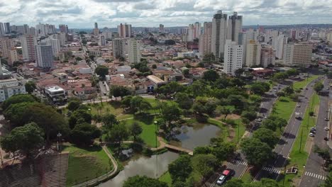 aerial flying over vitoria regia park towards center of bauru city, sao paulo, brazil