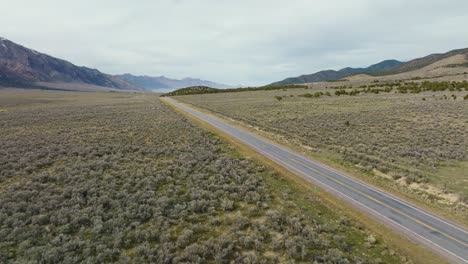 aerial - truck on highway next to scipio lake, utah, wide shot forward