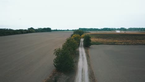 drone shot over the field road during harvest