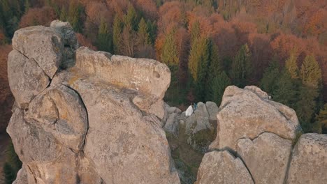 Newlyweds-stand-on-a-high-slope-of-the-mountain.-Groom-and-bride.-Arial-view