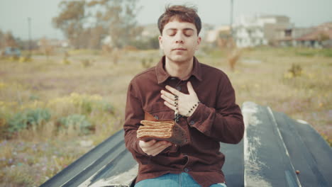 happy and joyful man praying in the nature with the bible book