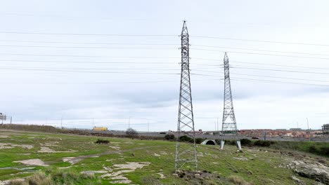 aerial view of transmission towers, high-voltage power grid and its transmission and distribution infrastructure