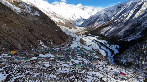 aerial drone shot capturing the pristine beauty of snow-covered chitkul, the last village of india.