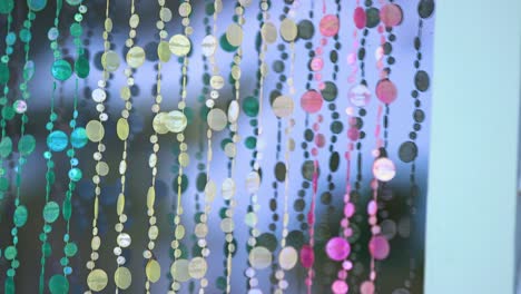 colorful circular garland draped over a window