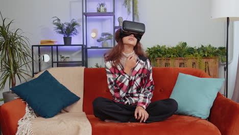 Girl-using-virtual-reality-futuristic-technology-headset-to-play-simulation-3D-video-game-at-home