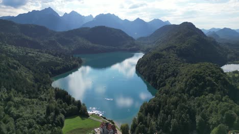 alpsee lake in germany near fussen drone aerial view sunny day clouds reflecting off lake