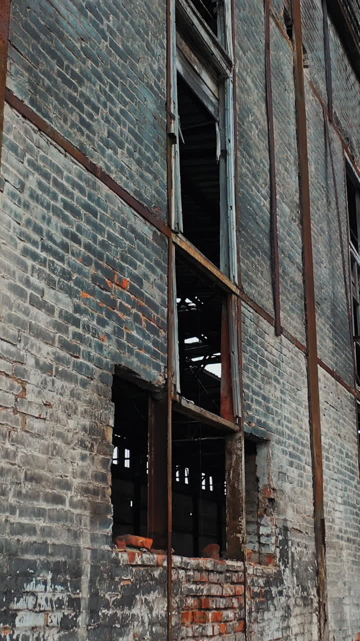 Ruins of an old factory. Old industrial building for demolition. Aerial view Vertical video