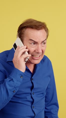 man expressing various emotions during a phone call