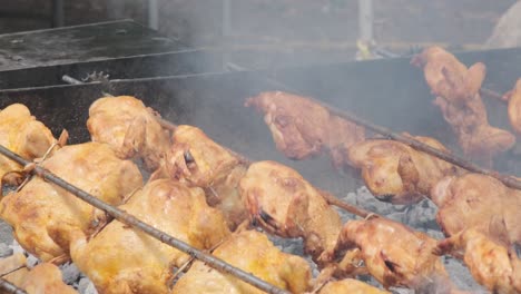 rotisserie chickens turning over flames in hawaii
