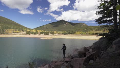 Young-man-fishes-in-low-water-Penrose-Rosemont-Reservoir,-Colorado