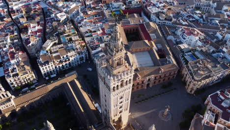 aerial half-orbit around iconic giralda tower of seville cathedral, spain