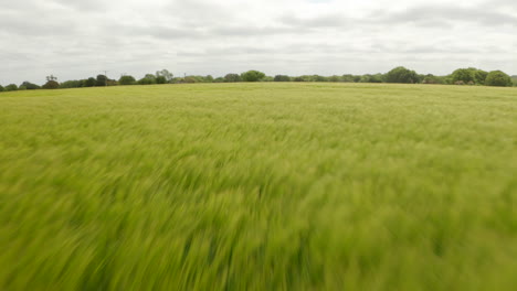 Rising-aerial-shot-over-farm-land-towards-Stevenage-town-UK