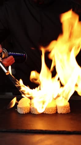 chef preparing flaming sushi