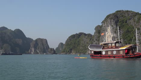 Exotic-red-tour-boat-motors-calm-water-in-Ha-Long-Bay-in-Vietnam