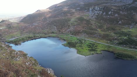 Wide-view-of-the-Gap-of-Dunloe-Ireland,-with-rock-cliff-walls-and-lake-in-the-valley